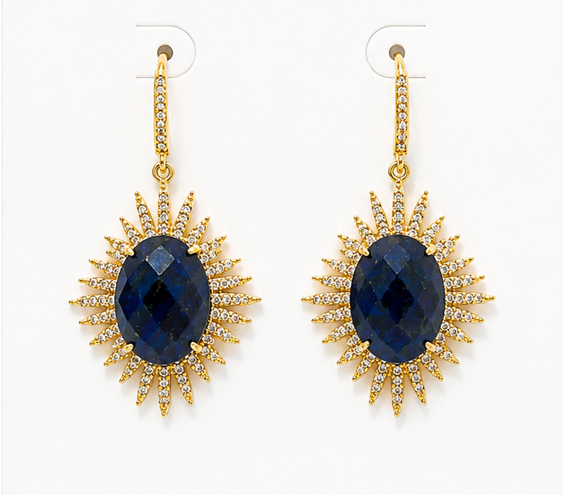 Pair of gold earrings with blue Lapis stones on a BOHO & MALA branded card.