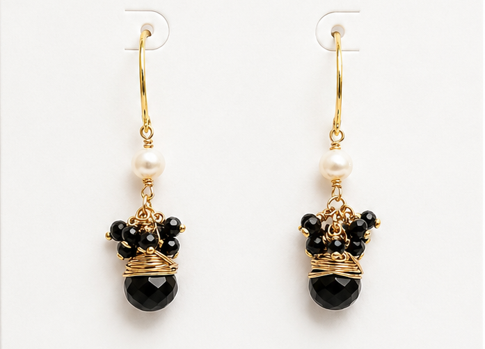 Pair of black beaded earrings on a BOHO & MALA branded card with a white background.
