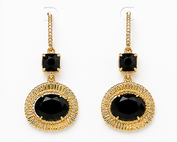 Gold earrings with black stones on a BOHO & MALA branded card.