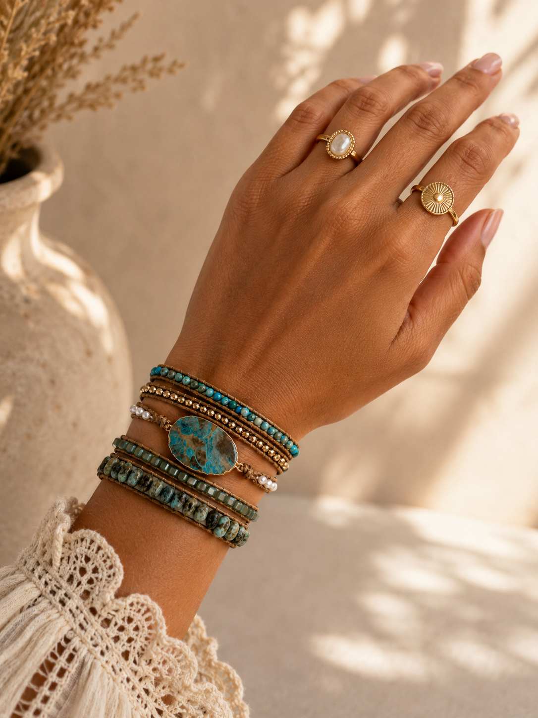 
                  
                    model wearing African turquoise beaded wrap bracelet on wrist with neutral background 
                  
                