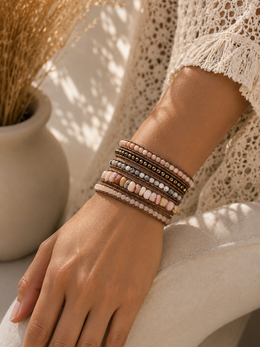 
                  
                    Hand wearing blush mixed wrap beaded bracelets with a neutral background
                  
                