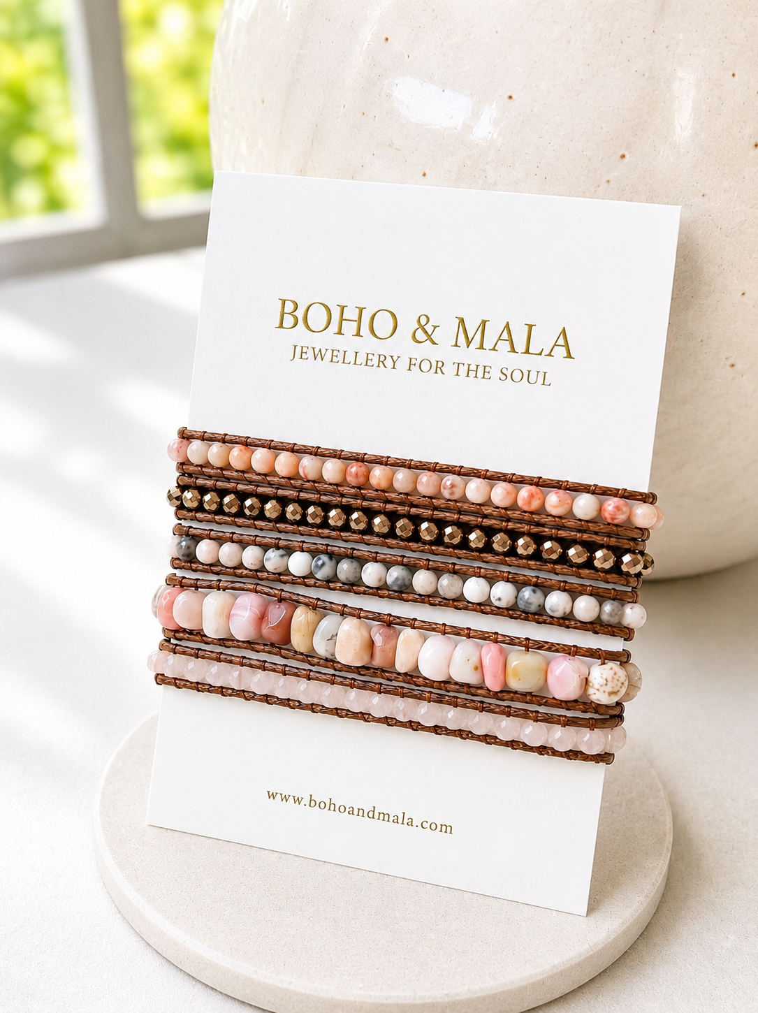 Stack of beaded blush mixed wrap bracelets on a card with 'Boho & Mala' branding.