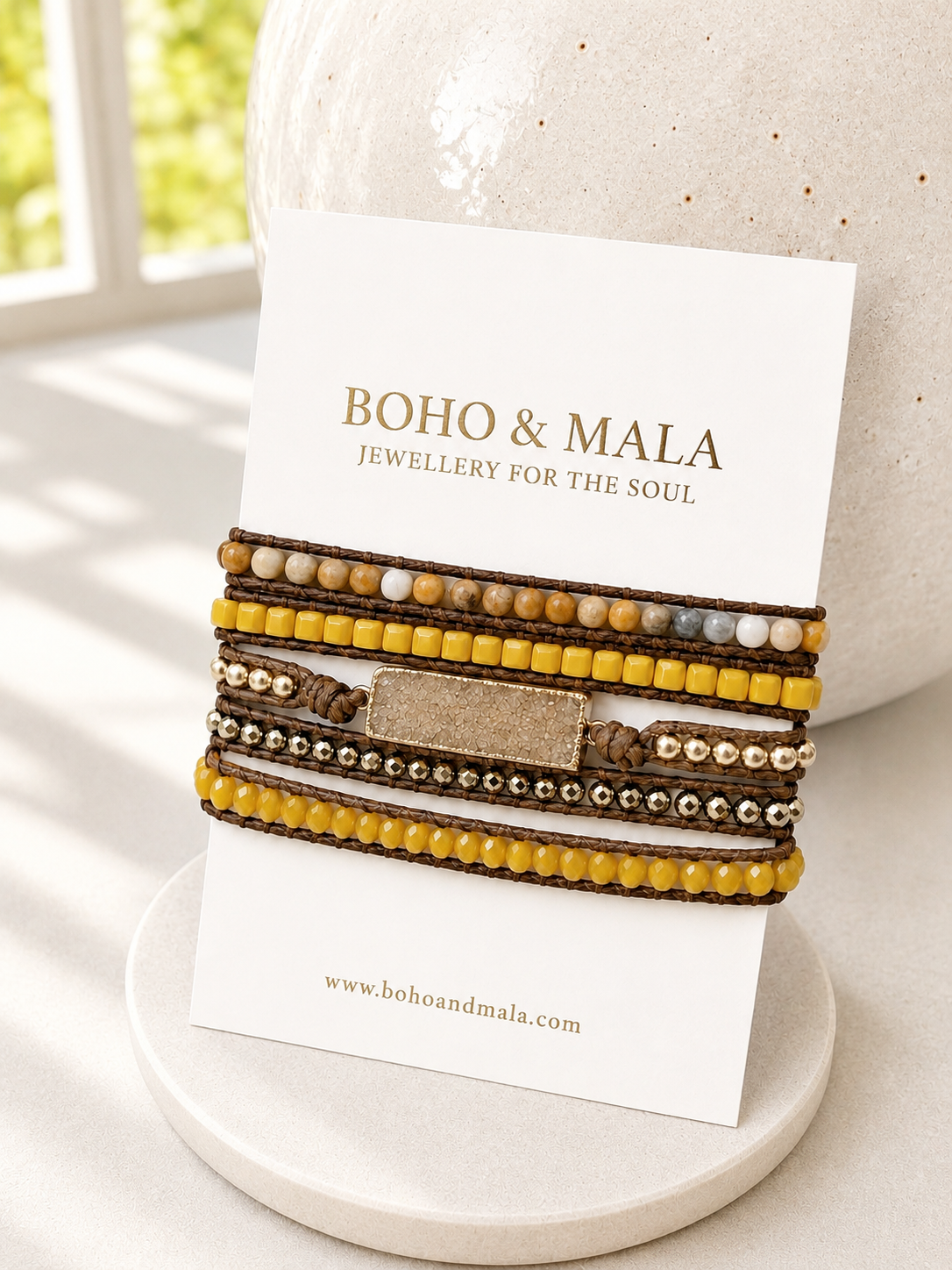 Set of beaded golden druzy wrap bracelets on a card with 'Boho & Mala' branding, displayed on a textured surface.