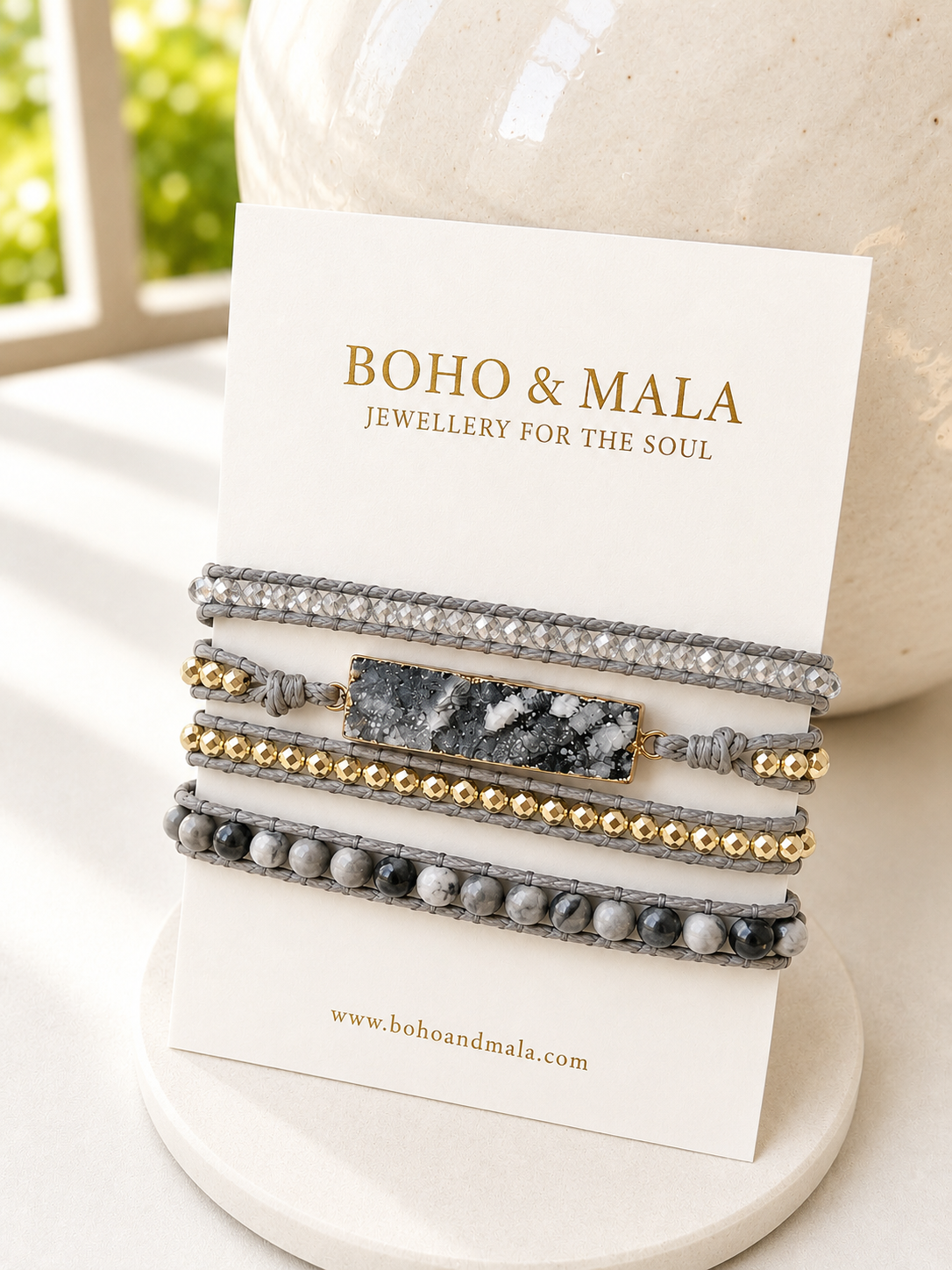 Set of grey druzy wrap bracelet on a display card with 'Boho & Mala' branding.