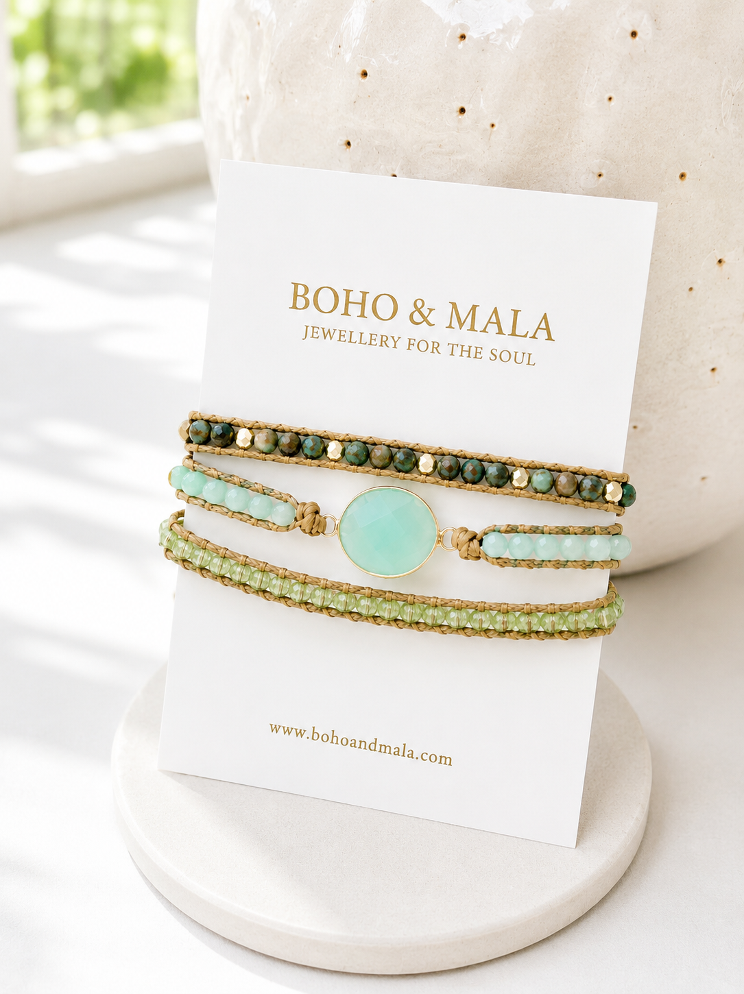 Set of beaded green mixed stone wrap bracelets on a card with 'Boho & Mala' branding, displayed on a textured surface.