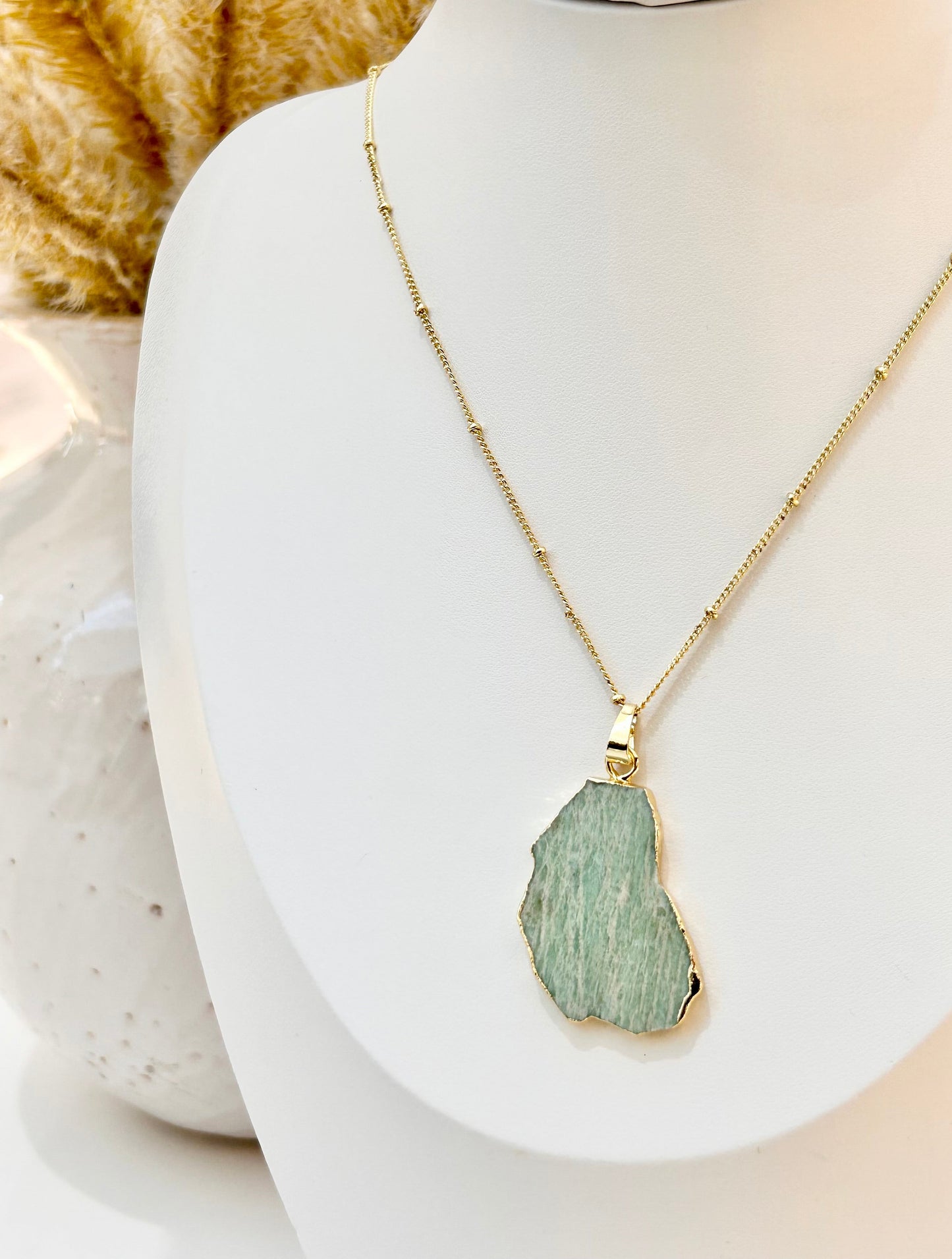 
                  
                    Necklace with a amazonite pendant on a mannequin bust
                  
                