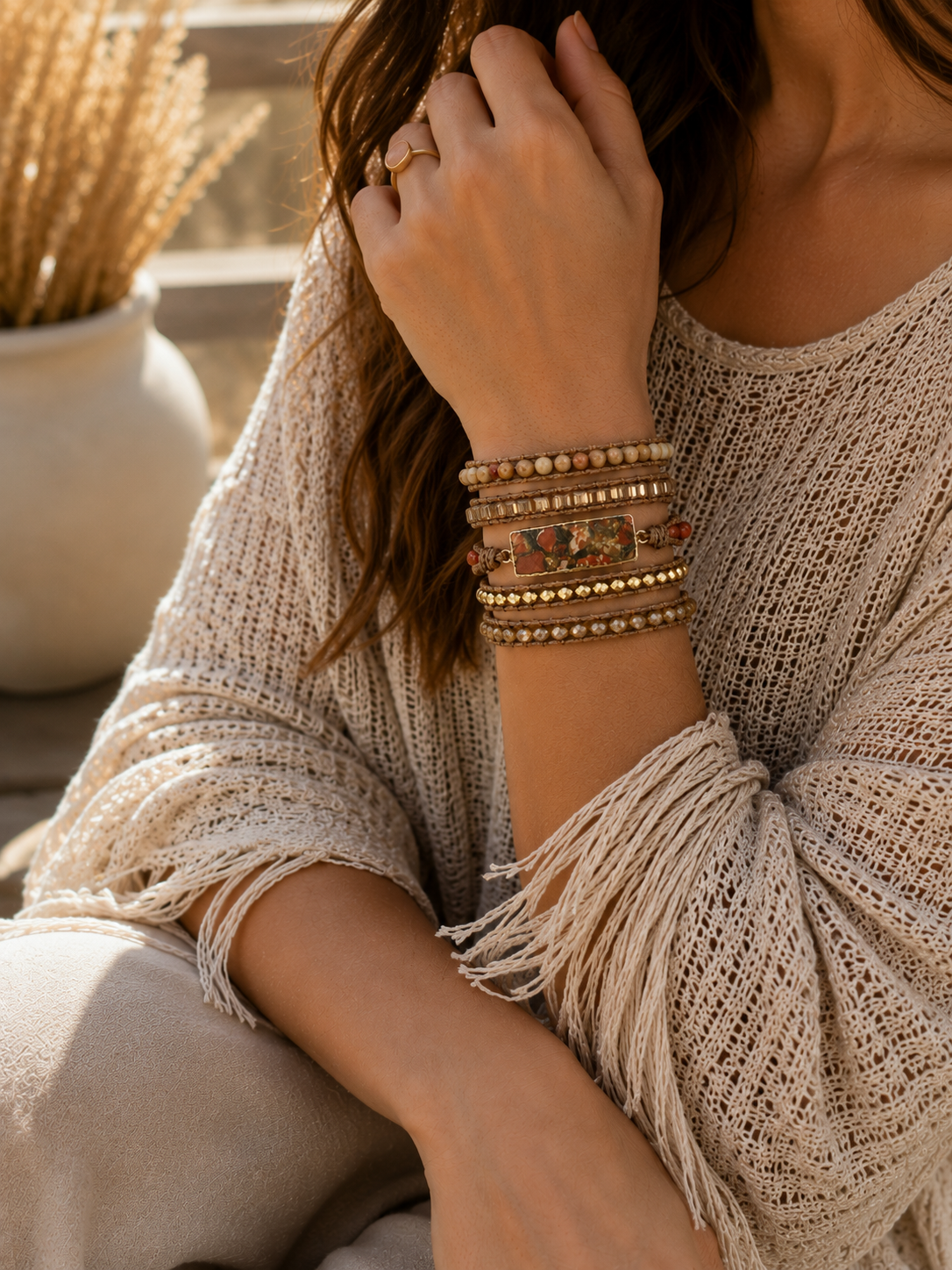 
                  
                    Person wearing natural stone red jasper wrap bracelets on a blurred natural background
                  
                